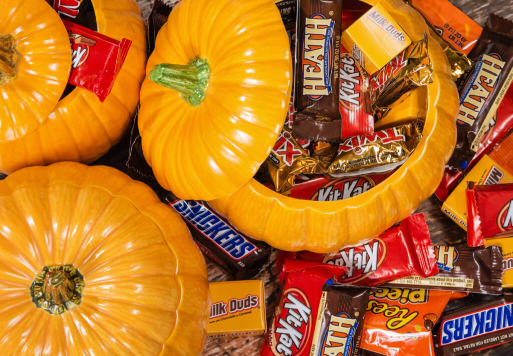 DALLAS, TX - OCTOBER 31, 2014: Decorative pumpkins filled with assorted Halloween chocolate candy made by Mars, Incorporated and the Hershey Company.